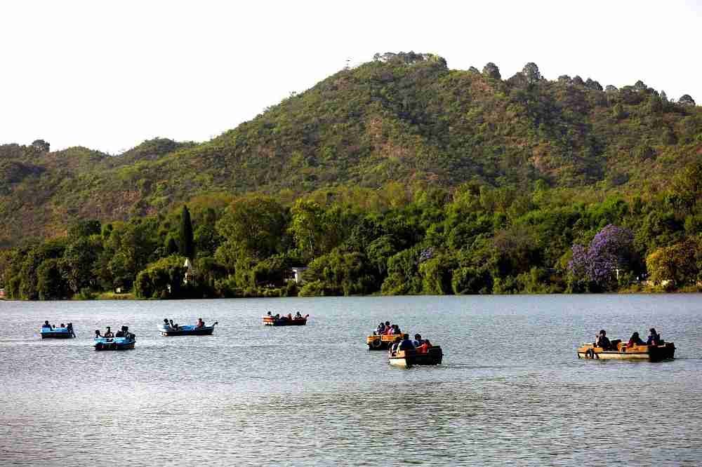 Mansar Lake, Jammu and Kashmir, is surrounded by green hills, forests and peaceful scenic landscapes.