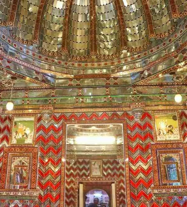 Sheesh Mahal Udaipur featuring intricate mirror work and magnificent royal palace interiors.